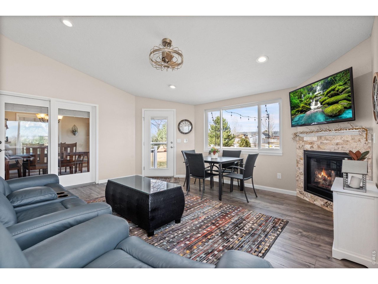 6345 Lesser Drive Greeley, CO 80634 - Photo 22 of 47 Family room (or sunroom) with gas fireplace and luxury vinyl flooring