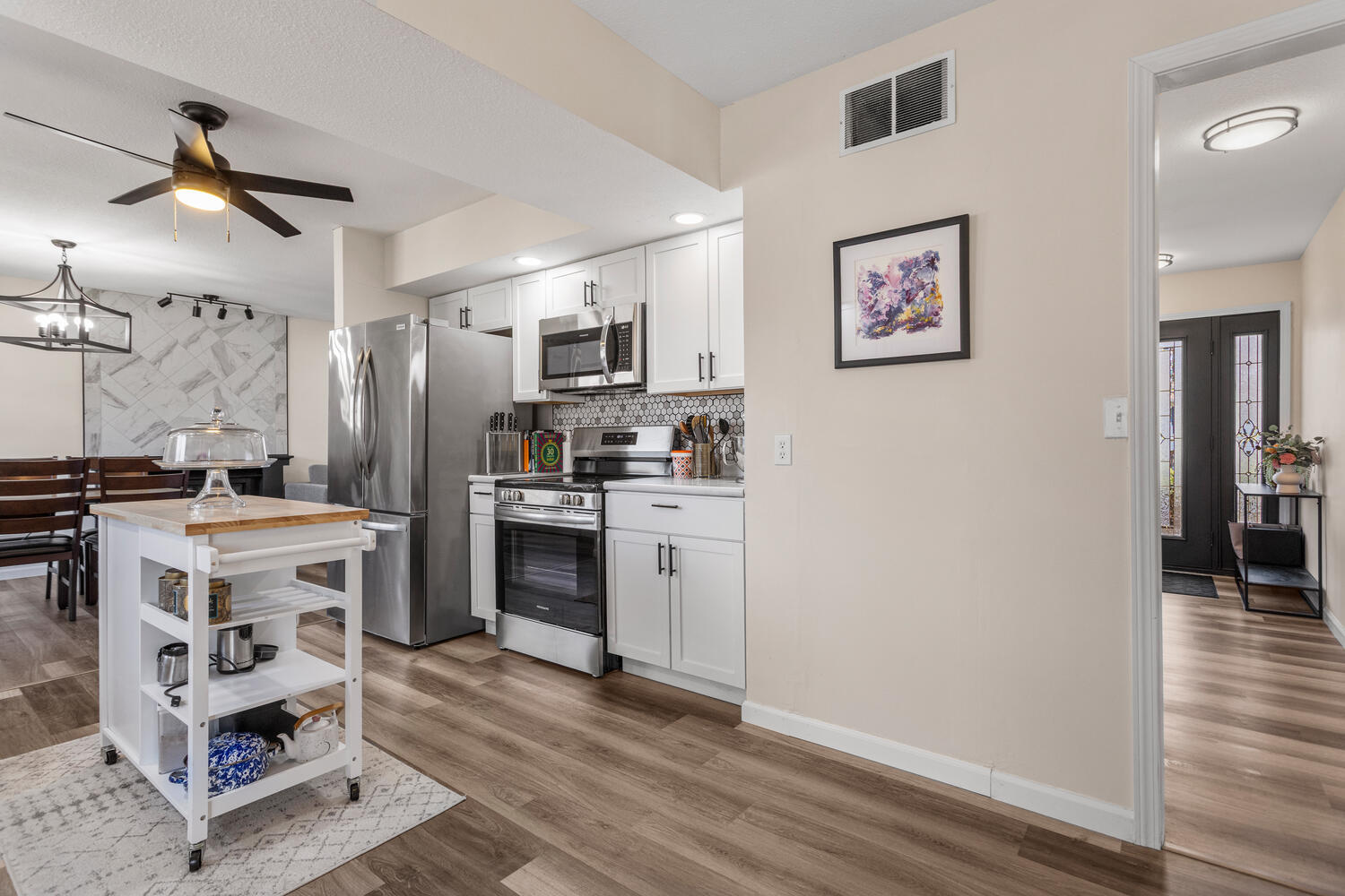 2317 Brookshire East Champaign, IL 61821 - Photo 15 of 32 a kitchen with a stove a refrigerator and a wooden floor