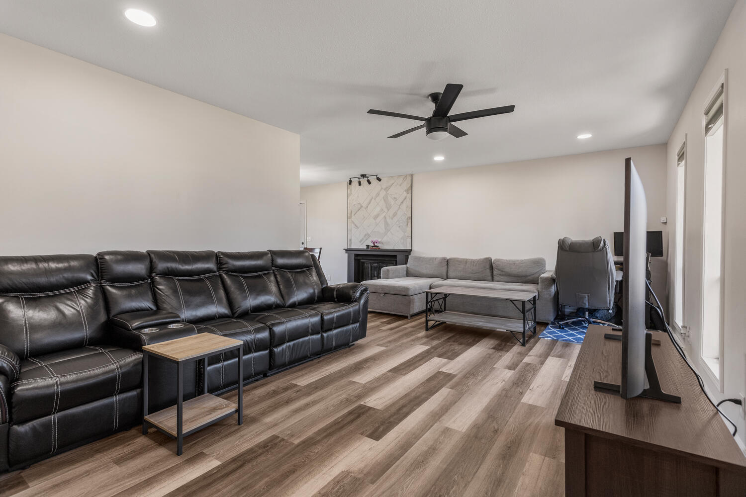 2317 Brookshire East Champaign, IL 61821 - Photo 6 of 32 a living room with furniture a flat screen tv and a ceiling fan