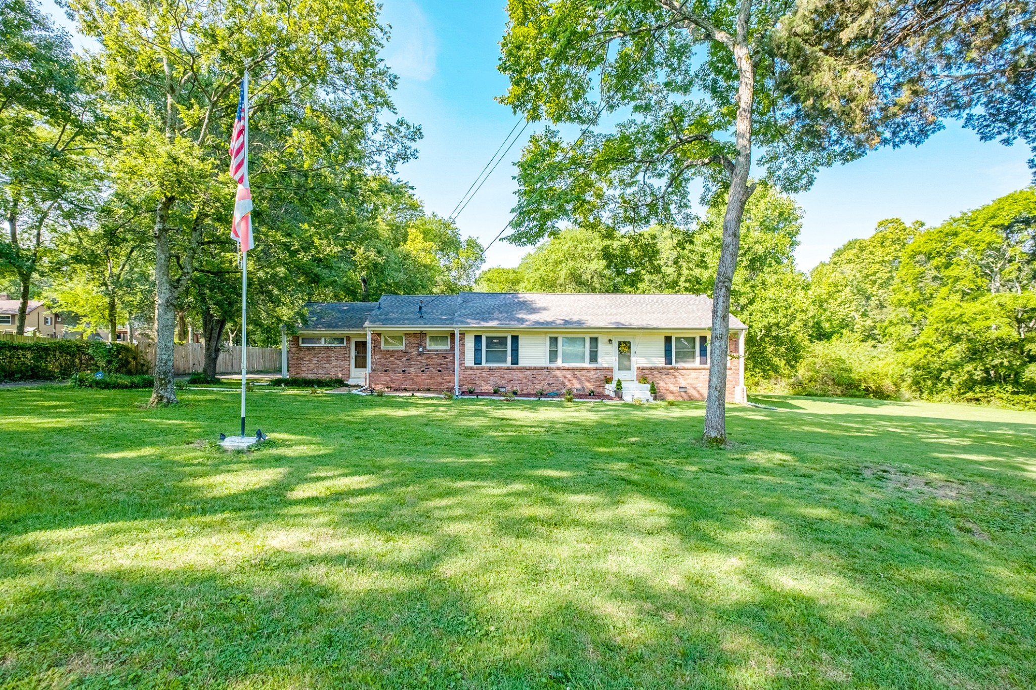 922 Neelys Bend Road Madison, TN 37115 - Photo 1 of 35 a view of a house with a big yard potted plants and large tree