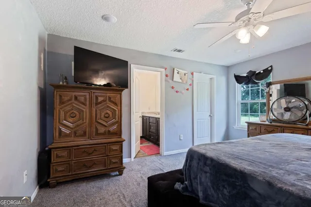 a bathroom with a toilet and a shower curtain