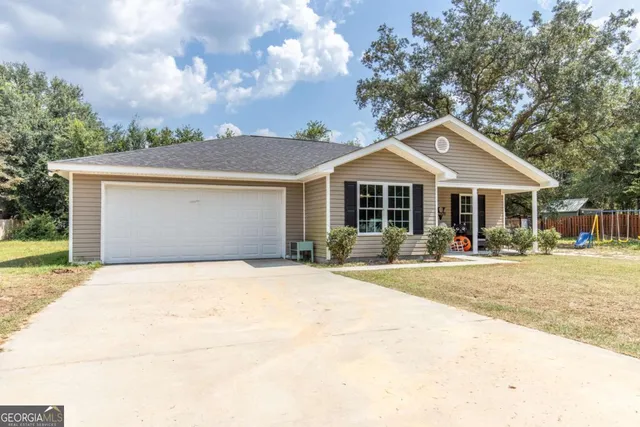 a front view of house with yard outdoor seating and green space