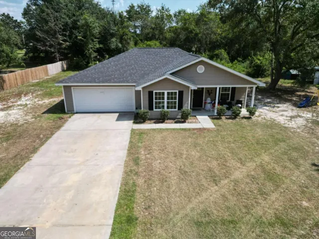 a aerial view of a house with a yard