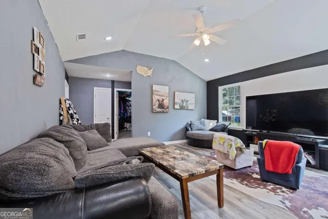 a living room with furniture and a flat screen tv