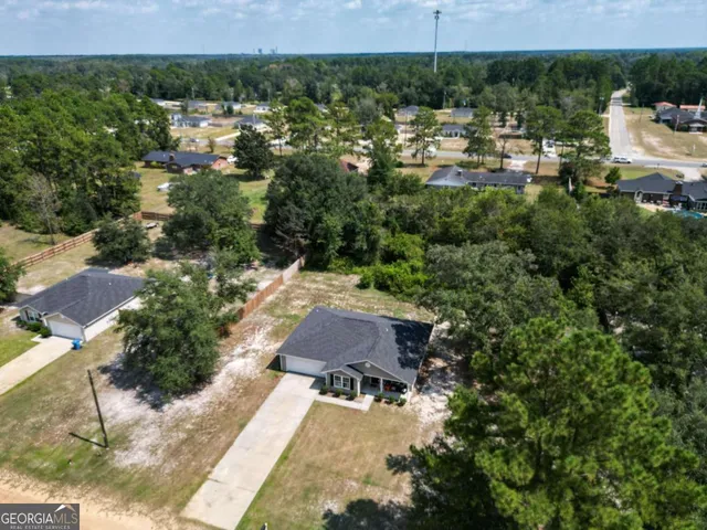 an aerial view of a house with a yard