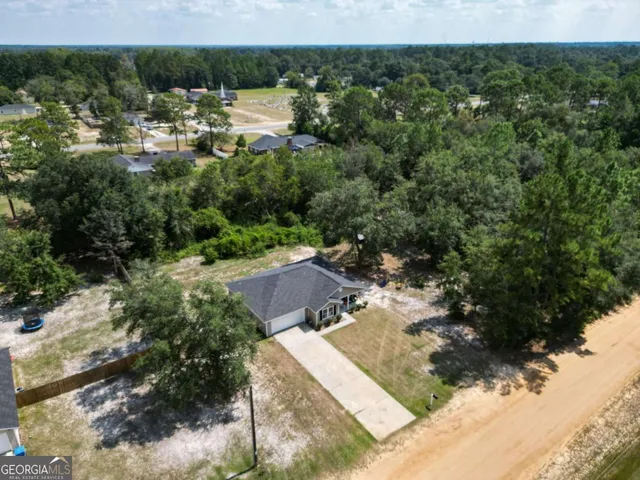 an aerial view of a house with a yard
