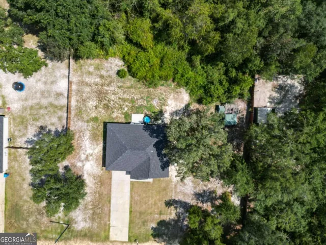 an aerial view of a house with a yard