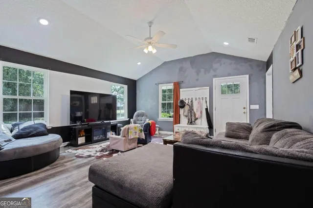 a living room with furniture and a flat screen tv