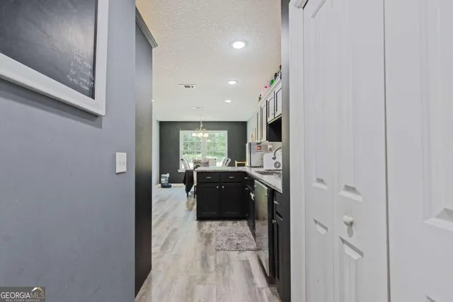a kitchen with sink and refrigerator