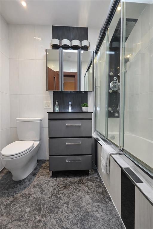 1956 20th Drive Brooklyn, NY 11214 - Photo 14 of 16 a bathroom with a toilet a sink and shower