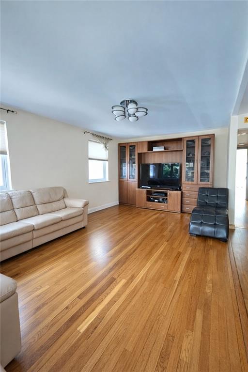1956 20th Drive Brooklyn, NY 11214 - Photo 6 of 16 a living room with furniture and a wooden floor