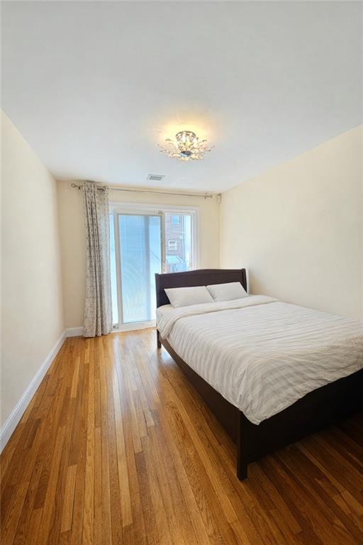 1956 20th Drive Brooklyn, NY 11214 - Photo 8 of 16 a bedroom with a bed and a window