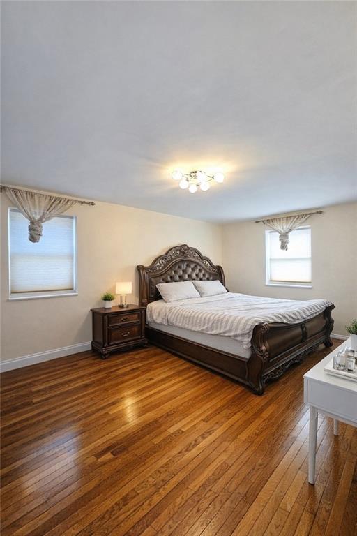 1956 20th Drive Brooklyn, NY 11214 - Photo 9 of 16 a spacious bedroom with a bed and wooden floor