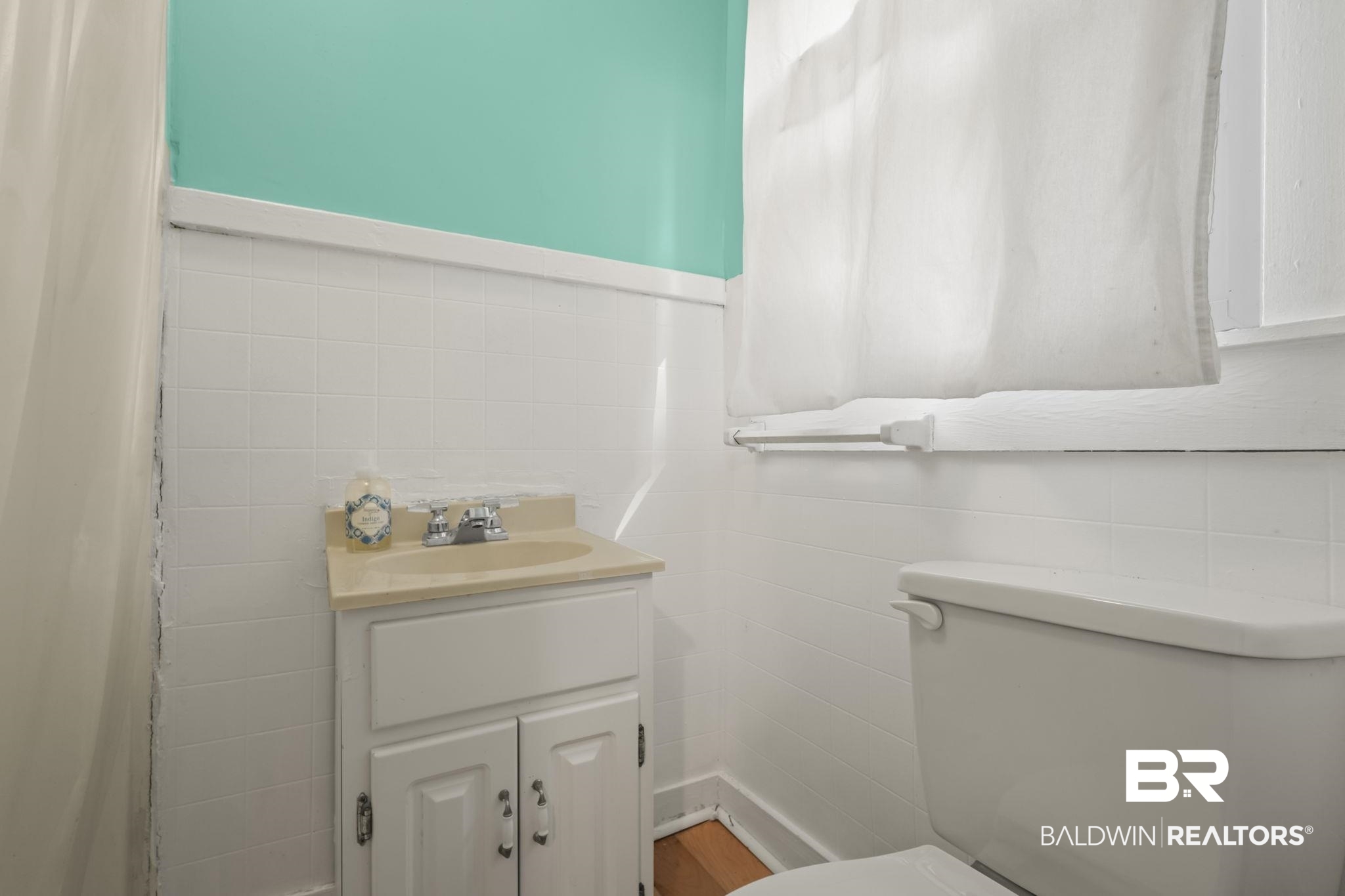 18696 Borck Road Gulf Shores, AL 36542 - Photo 12 of 47 Bathroom with vanity, tile walls, and toilet