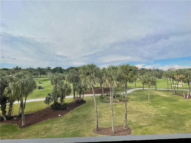 a view of a golf course with outside space