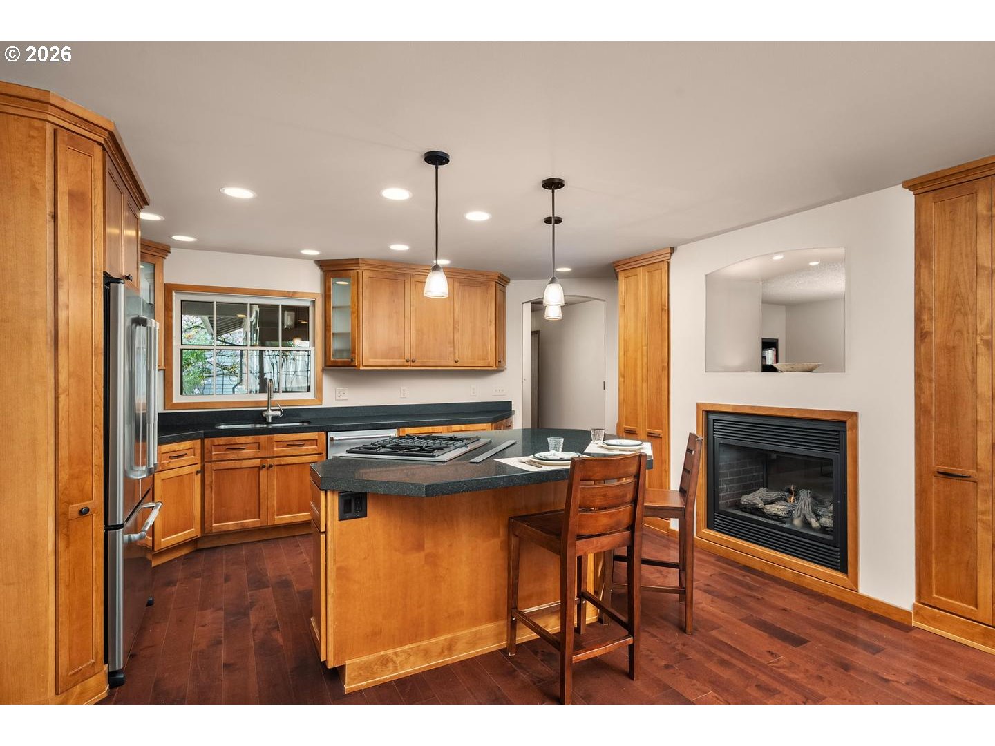 3005 Southwest 113th Avenue Beaverton, OR 97005 - Photo 7 of 30 a kitchen with stainless steel appliances granite countertop a stove refrigerator and wooden floor