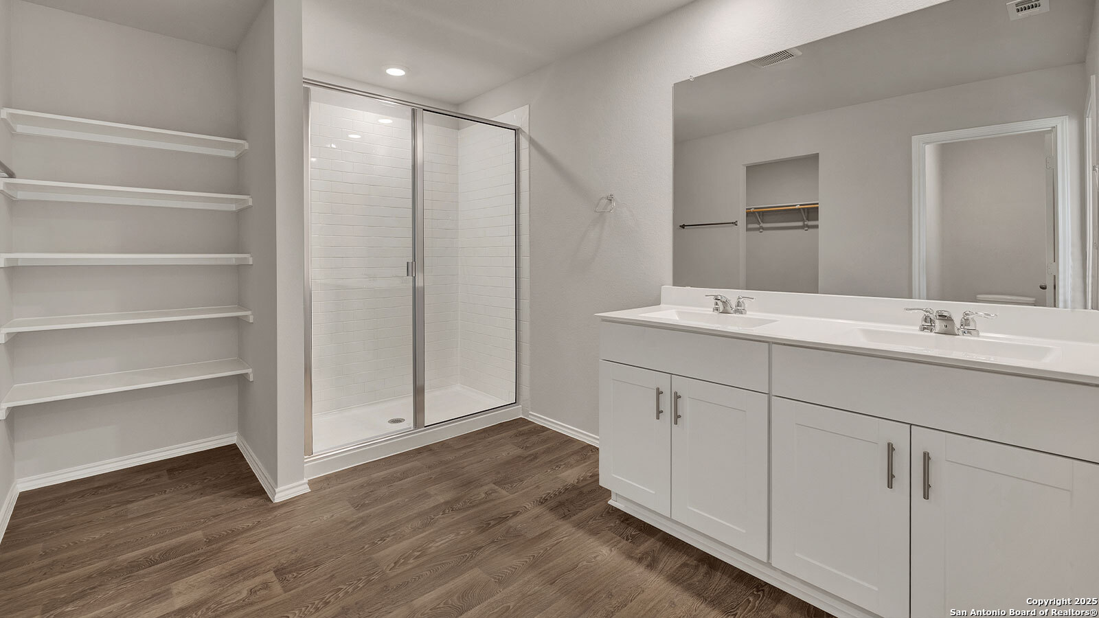 322 Hodges Street Maxwell, TX 78656 - Photo 23 of 34 a spacious bathroom with a double vanity sink and a mirror