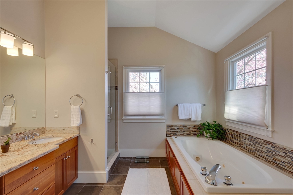 29 Old Bridge Road Concord, MA 01742 - Photo 16 of 40 a bathroom with a granite countertop tub sink and mirror