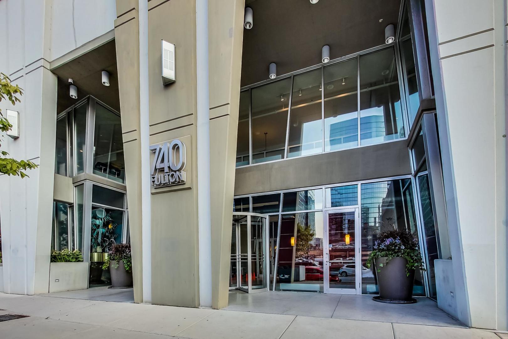 740 West Fulton Street, Unit 905 Chicago, IL 60661 - Photo 2 of 23 a front view of a building with glass windows