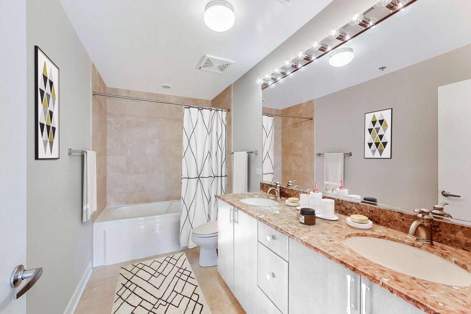 740 West Fulton Street, Unit 905 Chicago, IL 60661 - Photo 14 of 23 a bathroom with a double vanity sink a mirror a bathtub and next to a window