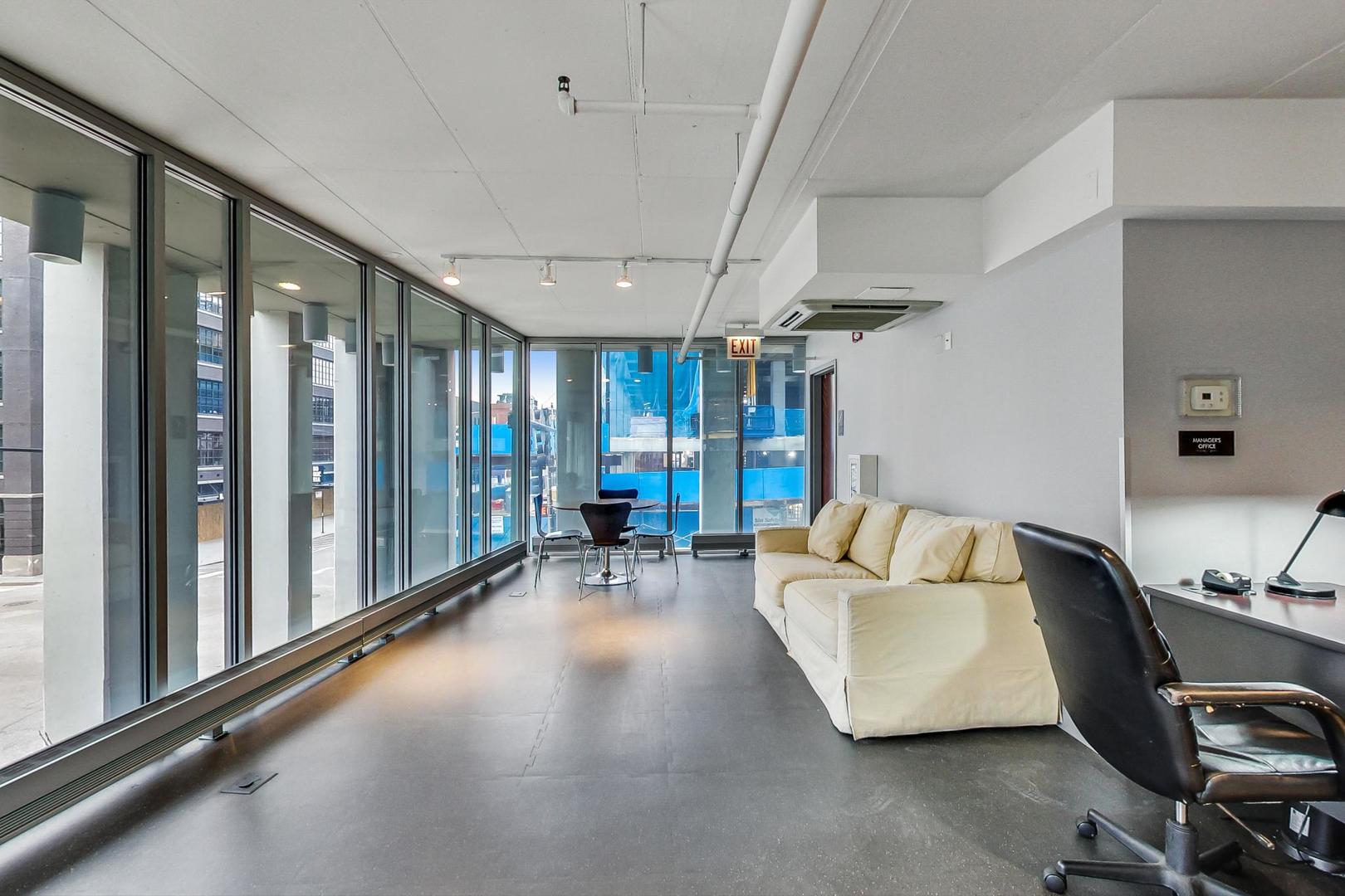 740 West Fulton Street, Unit 905 Chicago, IL 60661 - Photo 21 of 23 a living room with furniture and a large window