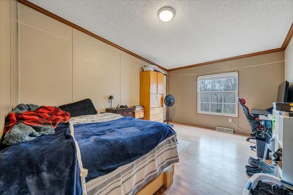 a bedroom with two beds and a lamp on the table