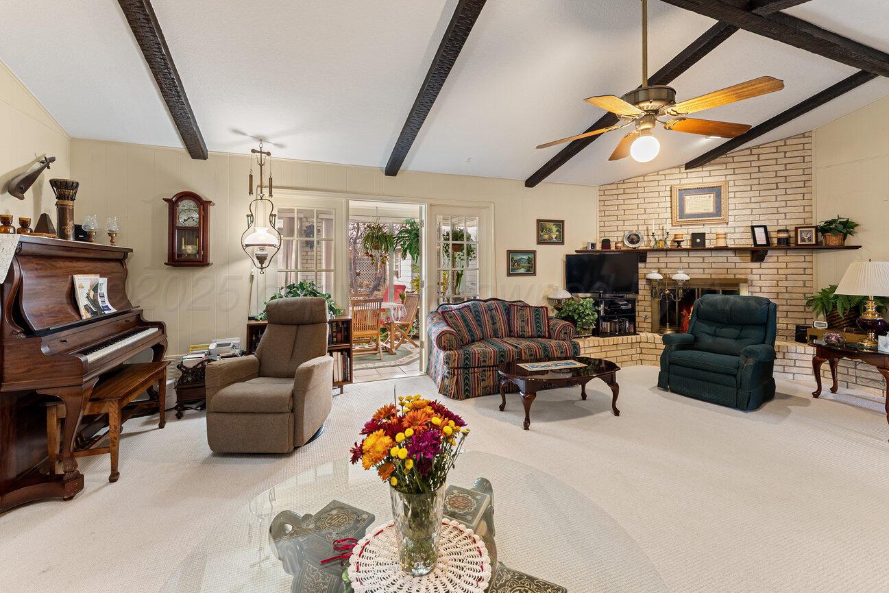 201 Carson Avenue Dumas, TX 79029 - Photo 11 of 55 a living room with furniture and a flat screen tv