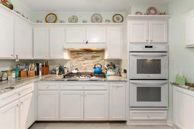 a view of a kitchen with cabinets and wooden floor