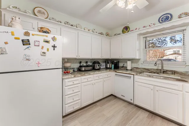 a view of a house with a yard and wooden fence