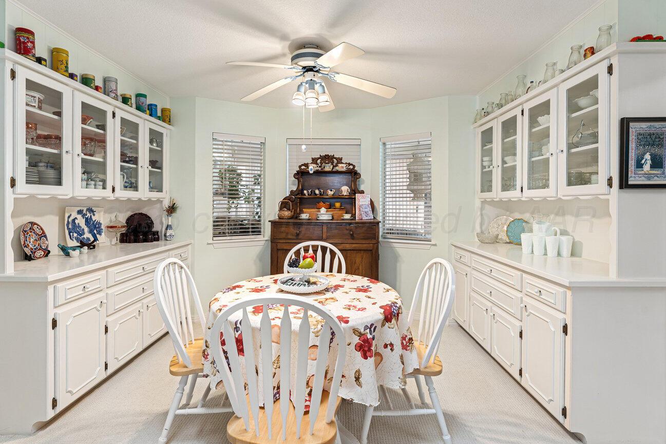 201 Carson Avenue Dumas, TX 79029 - Photo 18 of 55 a bedroom with furniture and a chandelier