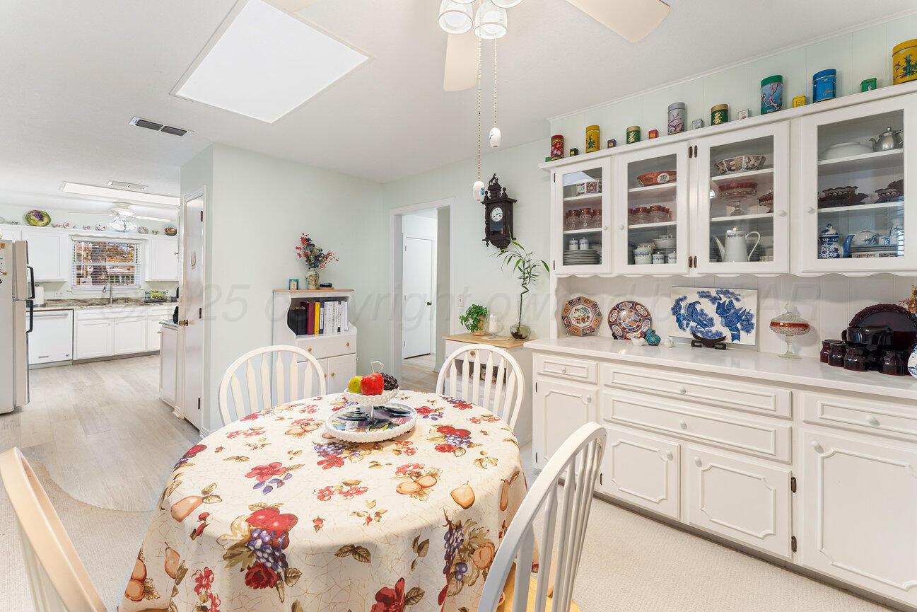 201 Carson Avenue Dumas, TX 79029 - Photo 20 of 55 a bedroom with a bed a dresser and next to a window