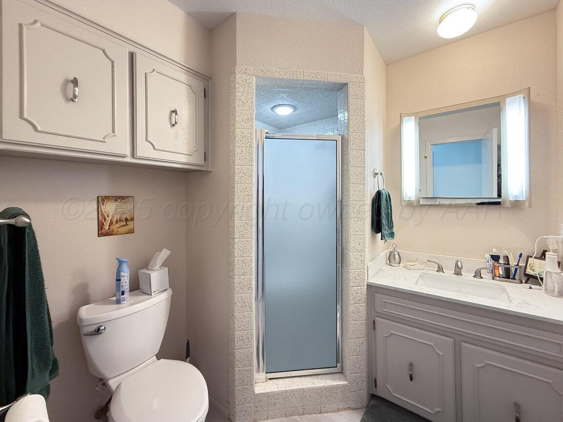 201 Carson Avenue Dumas, TX 79029 - Photo 29 of 55 a bathroom with a toilet sink and mirror