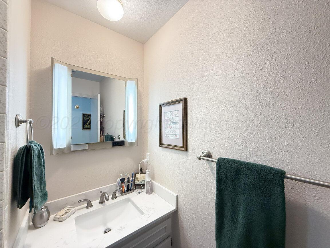 201 Carson Avenue Dumas, TX 79029 - Photo 30 of 55 a bathroom with a sink and a mirror