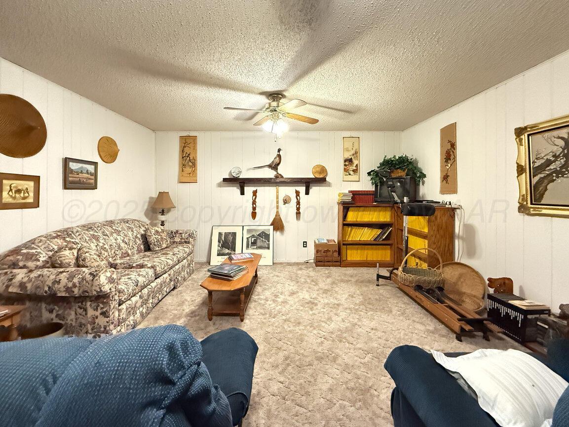 201 Carson Avenue Dumas, TX 79029 - Photo 37 of 55 a living room with furniture and a flat screen tv