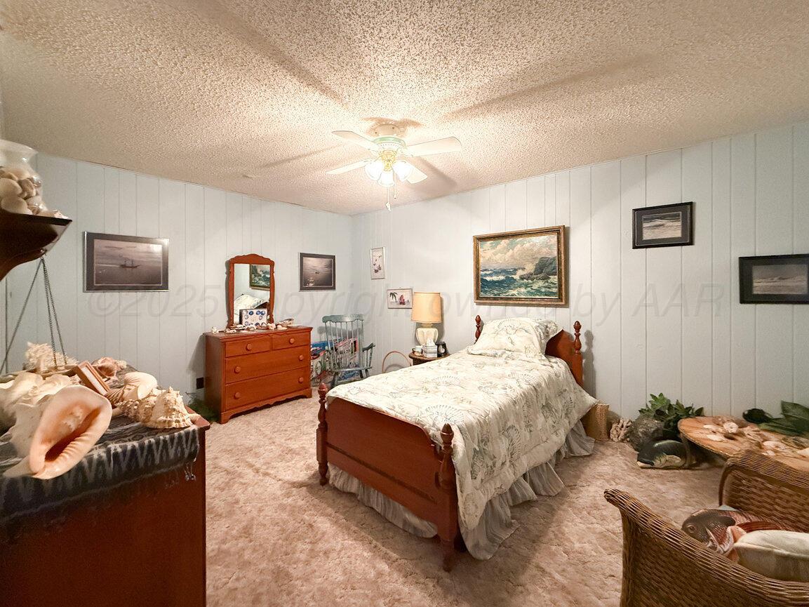 201 Carson Avenue Dumas, TX 79029 - Photo 41 of 55 a bedroom with a bed and wooden floor