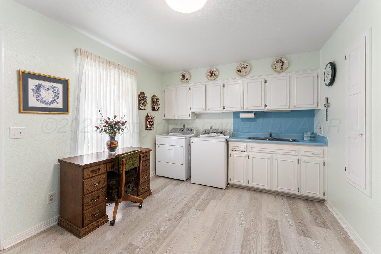 201 Carson Avenue Dumas, TX 79029 - Photo 43 of 55 a kitchen with granite countertop a sink cabinets stainless steel appliances and a window
