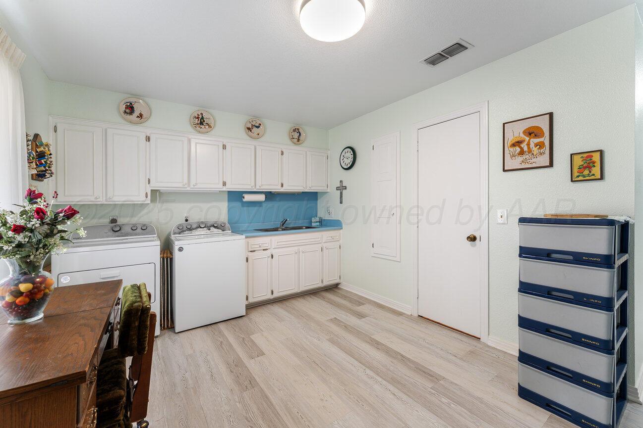 201 Carson Avenue Dumas, TX 79029 - Photo 44 of 55 a kitchen with granite countertop white cabinets and white appliances