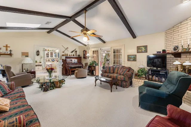 a living room with furniture a rug and a window