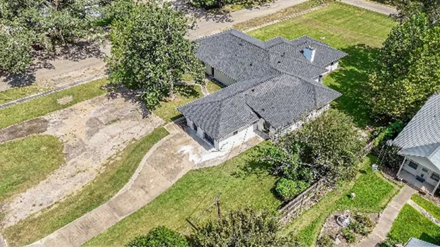an aerial view of a house with a yard