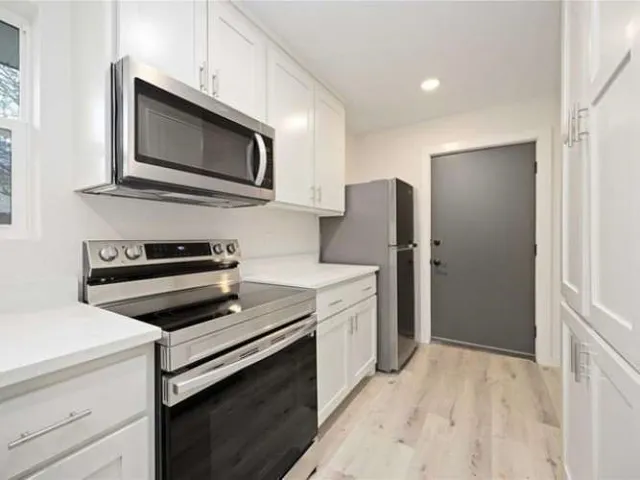 a kitchen with a microwave stove and refrigerator