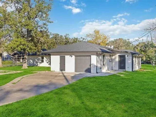 a front view of a house with a yard and porch