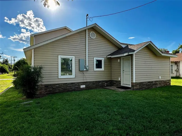 a front view of house with a garden
