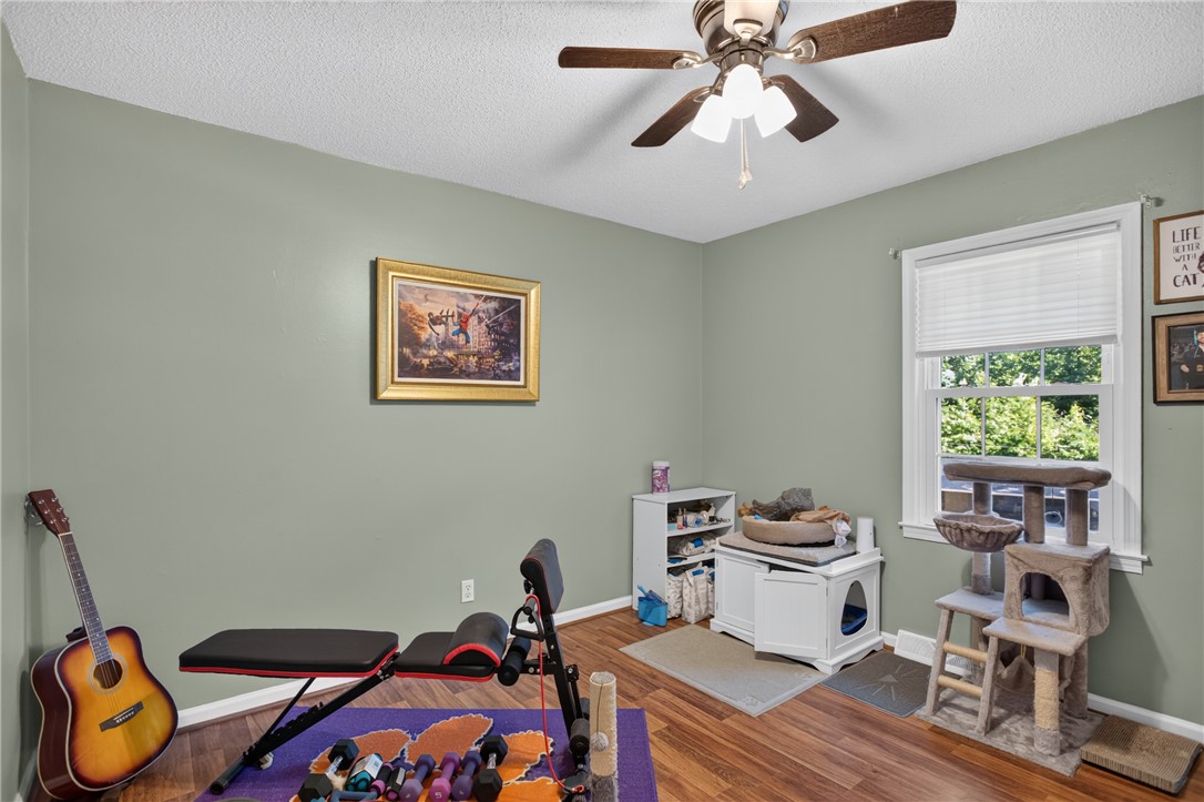 104 Laurel Lane Seneca, SC 29678 - Photo 20 of 36 Hardwood flooring extends throughout this versatile space, featuring a window and a ceiling fan for comfort.