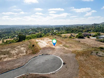 a view of a swimming pool with a yard and mountain view