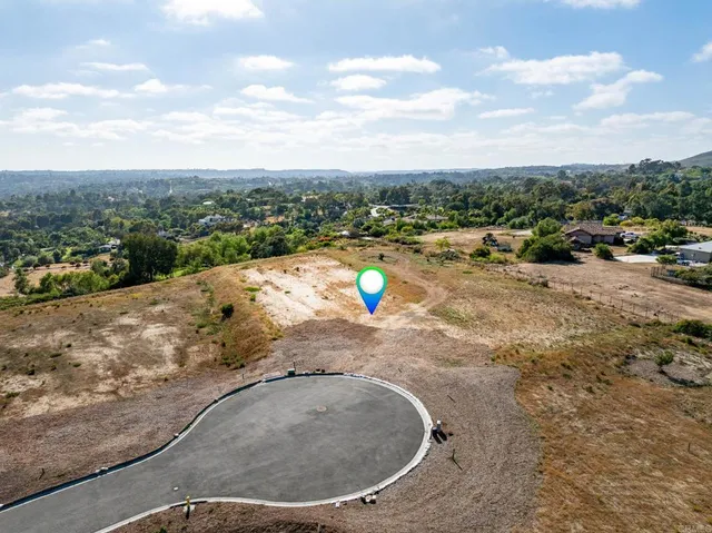 a view of a swimming pool with a yard and mountain view