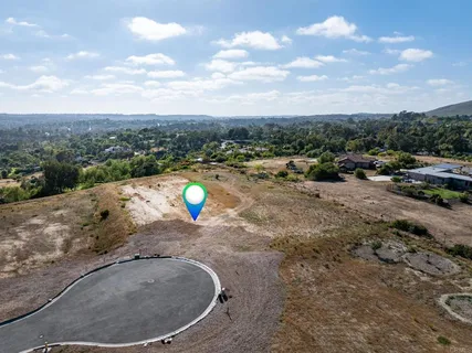 a view of a lake with a yard and car parked