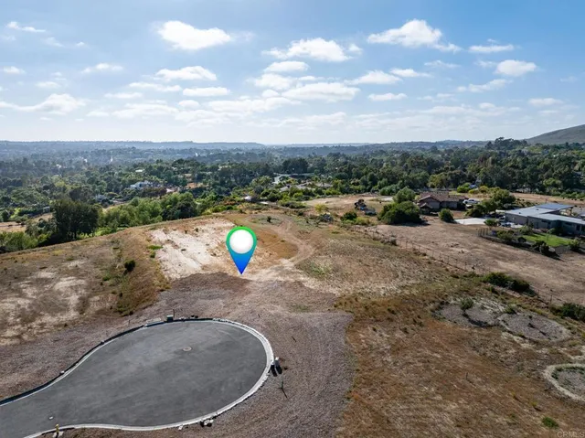 a view of a lake with a yard and car parked