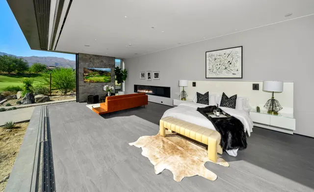 a bedroom with furniture and a large window