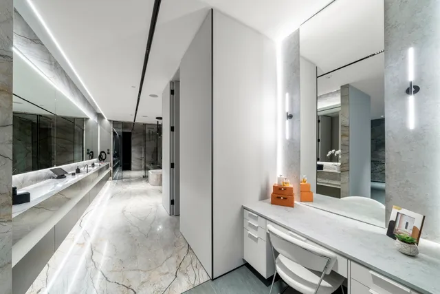 a room with a bed and a large mirror on the dresser