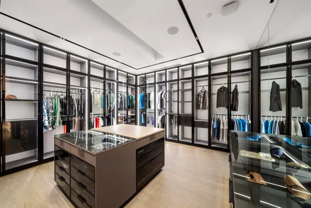 a living room with large window and furniture